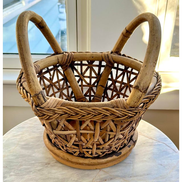 Vintage hand-woven basket with braided trim. Two sturdy handles anchor this basket, and it is perfect as an accent piece,...
