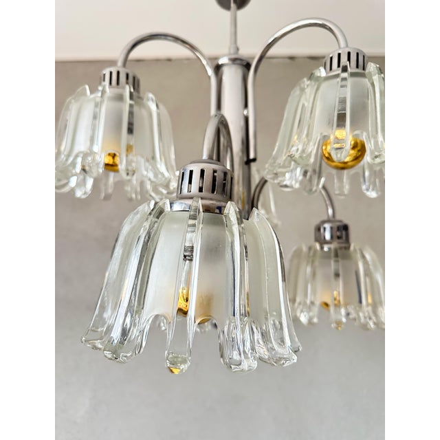 Beautiful mid - Century design. 1970s pendant lamp made by the German company Doria Leuchten. Chrome frame with 6 thick-...