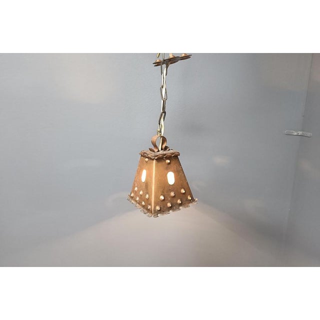 Vintage brutalist hammered copper sheet pendant light. The lamp emits a nice diffuse light thanks to the perforated shade....