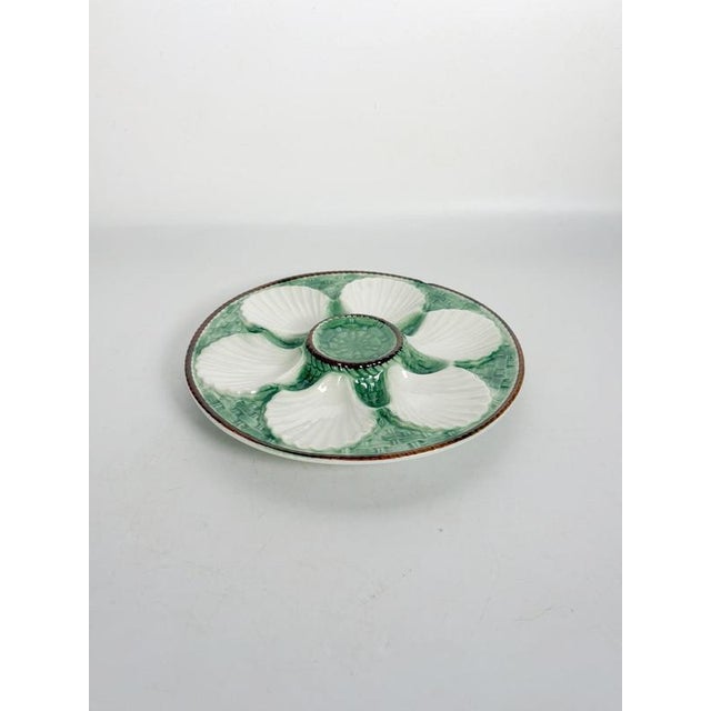 Beautiful 19th-century French majolica oyster plate, distinguished by its elegant circular shape, delicate shell-shaped...