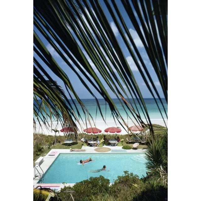 The Bahamas 1967 by Slim Aarons Slim Aarons Limited Estate Edition Swimming pool, seen through the fronds of a palm tree,...