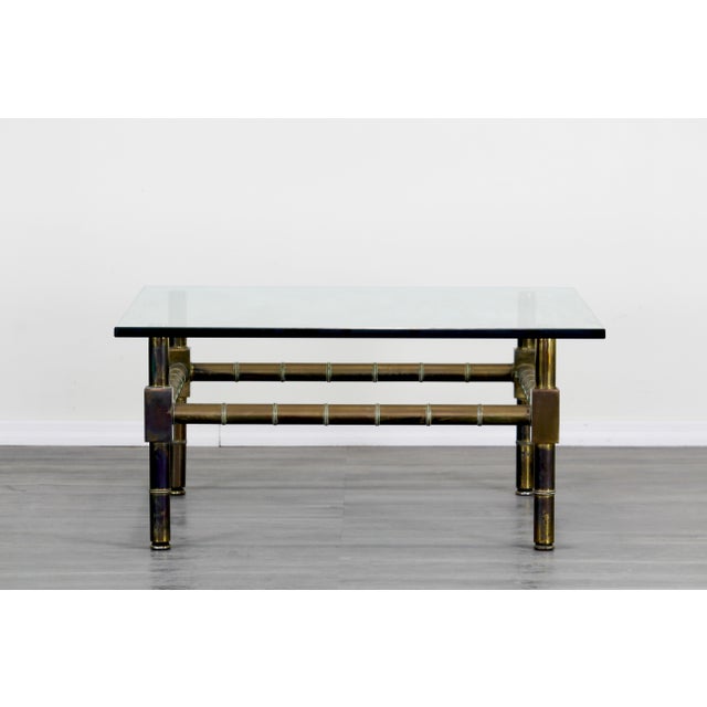 Mid Century Mastercraft attributed brass coffee table with glass top This table has a nice vintage patina Dimensions:...