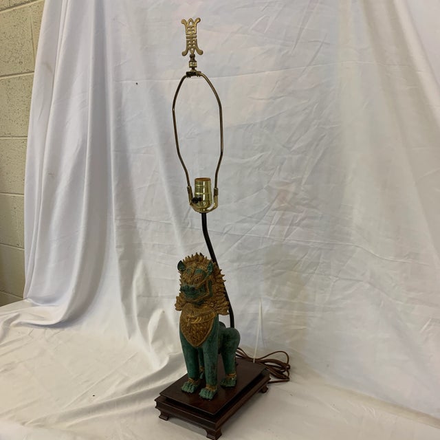 Super fab Singha lion bronze and gold gilt mane and accents table lamp mounted to wood base. Nice brass finial. No lamp...