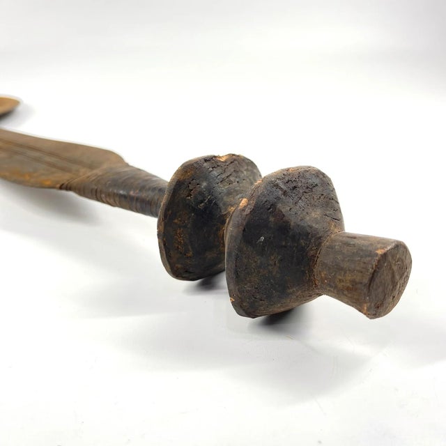 The Ngombe Executionerâs Prestige Knife Currency from the Congo is a powerful and visually striking object that embodies...