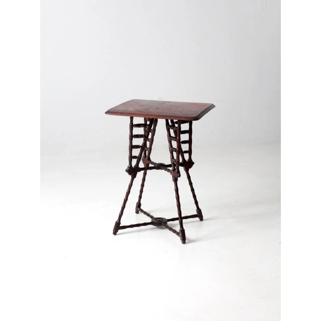 An antique Victorian “Stick and Ball” end table with a rich mahogany-toned finish and distinctive turned detailing. The...