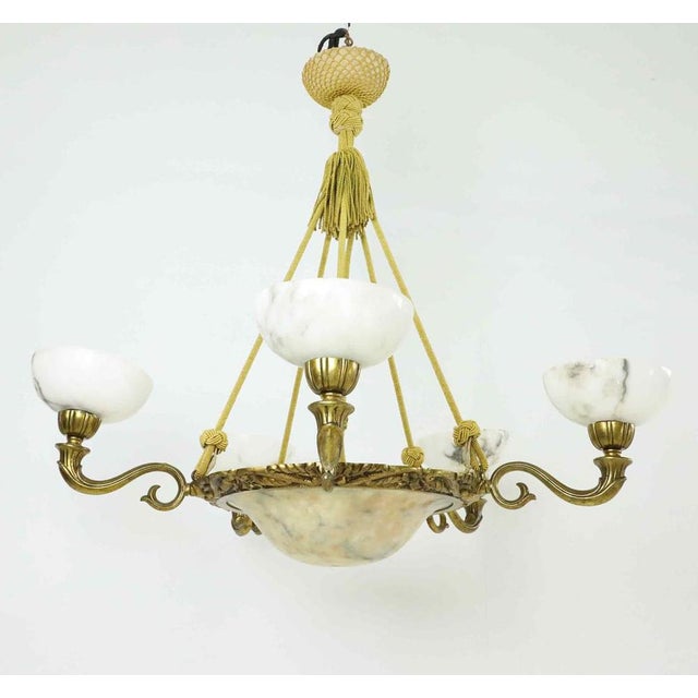 A refined six-light chandelier from Sweden, circa 1930s, featuring beautifully veined alabaster shades and a central...