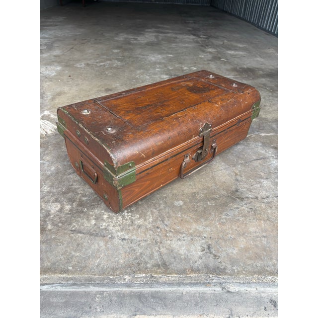A charming antique British colonial steel cabin trunk from early 20th-century England, featuring its original hand-painted...