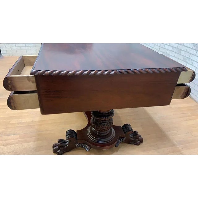 Antique Empire Carved Mahogany Partner’s Desk This beautiful empire partner desk from the early twentieth century is...