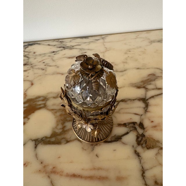 Mid Century cut crystal egg table lighter with gilt bronze setting. The egg sits in a gorgeous intricate stand of gilt...