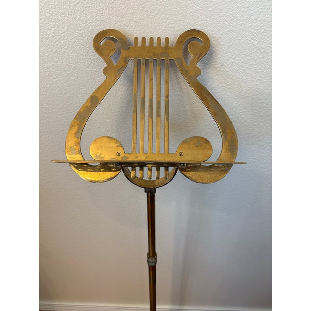 This vintge brass lyre music stand is on an adjustable telescopic pole. These stands typically feature a lyre motif for...