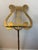 This vintge brass lyre music stand is on an adjustable telescopic pole. These stands typically feature a lyre motif for...