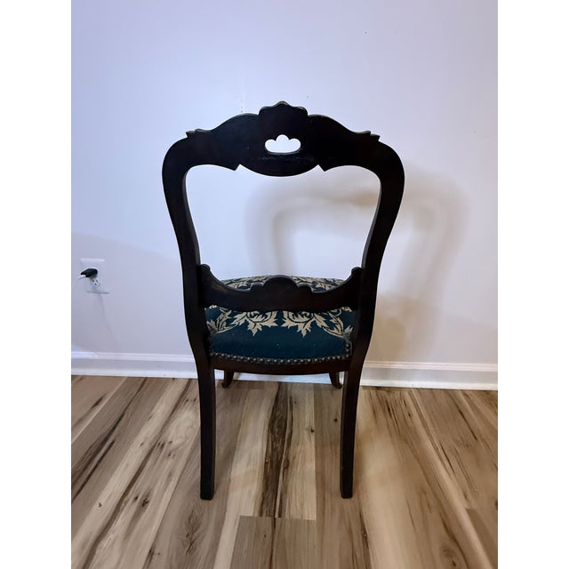 An elegant mid-19th-century Victorian balloon-back side chair, dating to approximately 1860, with a beautifully carved...