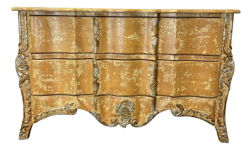 Front view of a distressed gold French Provincial commode chest of drawers.