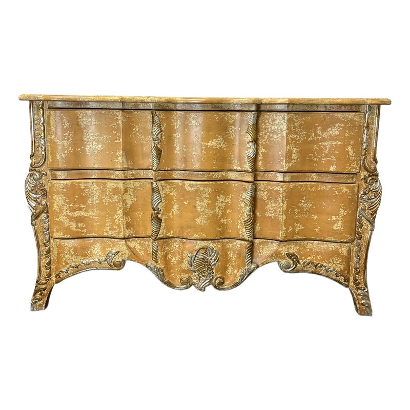 Gold-colored dresser with six drawers and ornate details