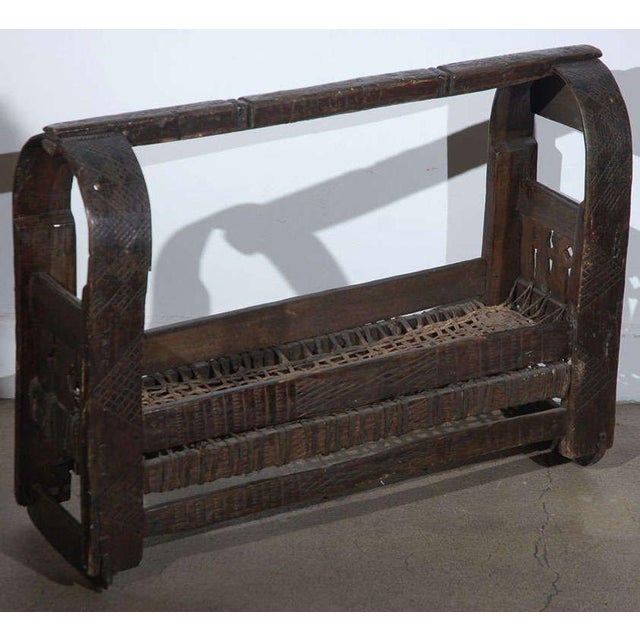 A rare antique Indian infant cradle, handcrafted circa 1900 and most likely originating from a rural community in western...