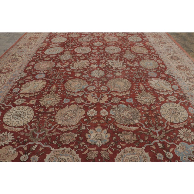 Hand-knotted in wool, this antique 13x19 Persian Tabriz rug, originating circa 1920-1940, represents a classic example of...