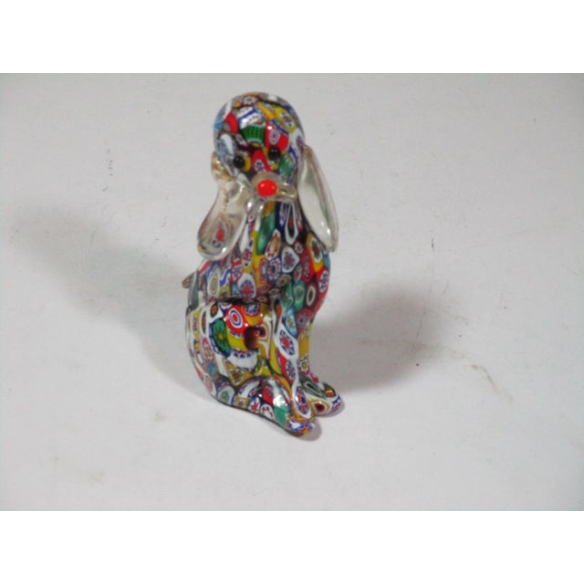 Handmade Art Glass Millefiori sitting dog figure made in Italy. It has clear glass ears with gold flecks and a clear mouth...