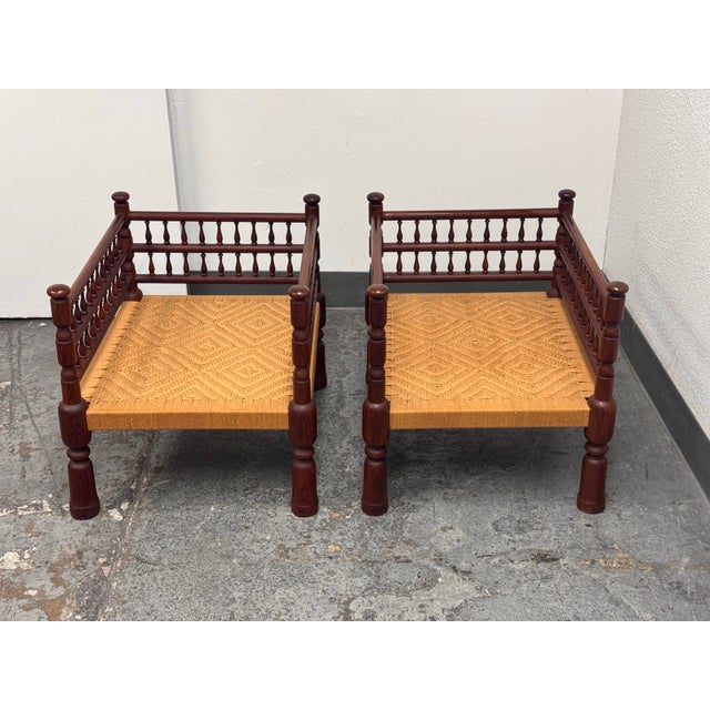 Design Plus Gallery presents a Pair of Indian Vintage Rush Seat Low Chairs. The pair has turned wood frames, rounded...