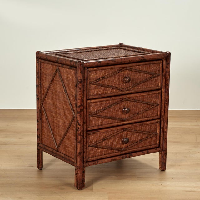 Handsome pair of mid century three drawer stands crafted with faux bamboo frames and grasscloth panels all around with...