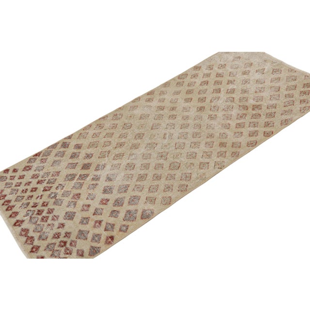 This vintage 3x6 rug, hand-knotted in wool, originating from Turkey, circa 1960-1970, features Zeki Müren’s mid-century...