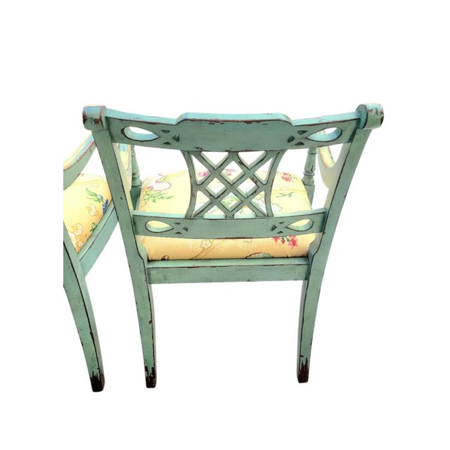 Exude grand millennial charm and Palm Beach Regency flair with this striking pair of vintage open-arm accent chairs....