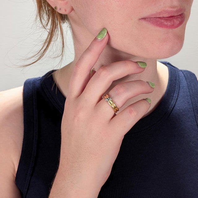 A fine, signed gold & diamond ring. By Tiffany & Co. In 18k yellow and white golds. Bezel set with 2 round white diamonds....