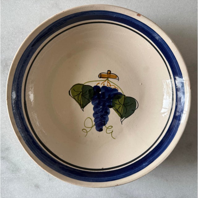 Set of 7 glazed pottery bowls with a grape design hand made in Italy by Lamas Ceramiche. Makers mark present on the bottom...