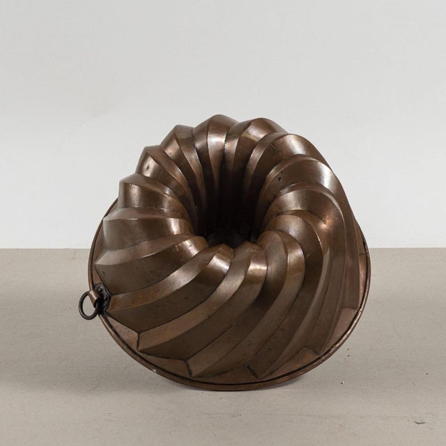 This copper cake pan is a true antique, with its classic design and generous size making it a visually striking piece. The...