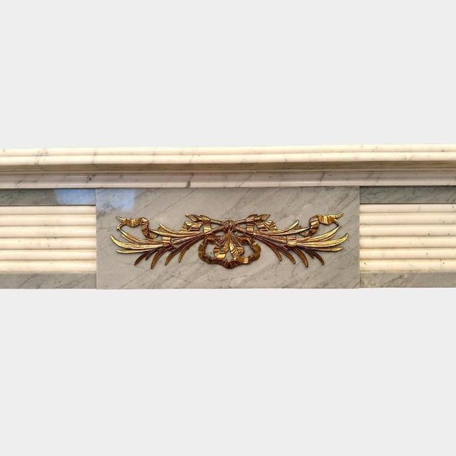 An early 20th century circa 1920's English Regency style fireplace surround in Italian Statuary white and Grey Bardiglio...