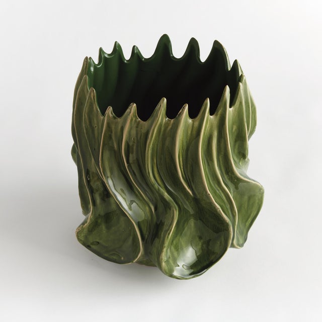 With a sculptural, luster effect, this unusual form of a vase truly captivates. Made of clay & finished with a highgloss...
