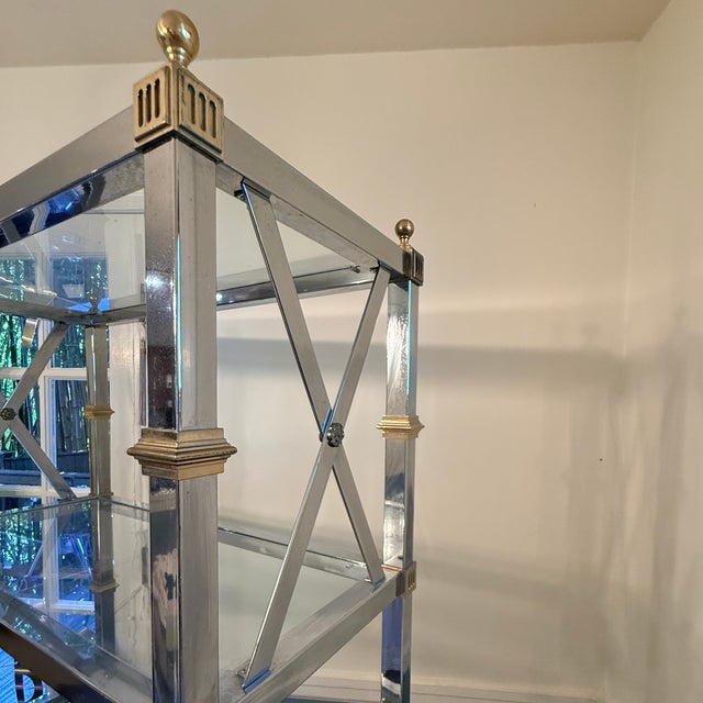 Vintage Hollywood Regency Chrome, Brass & Glass Étagère Five glass shelves inside a Maison Jansen style architectural...
