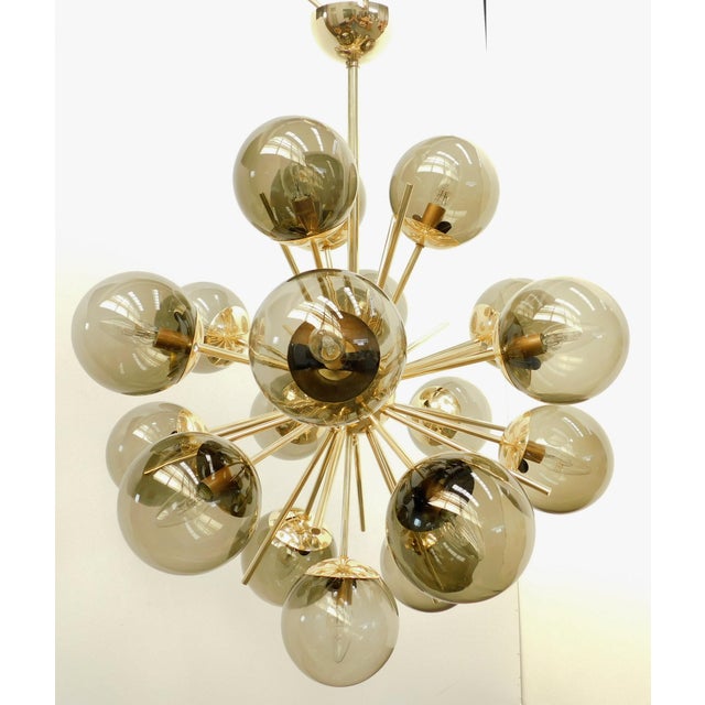 Italian sputnik chandelier with 18 smoky Murano glass globes mounted on brass frame in lacquered polished brass finish /...
