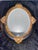 Vintage Oval Convex Mirror With Black and Gold Ornate Wooden Frame. For Sale - Image 4 of 12