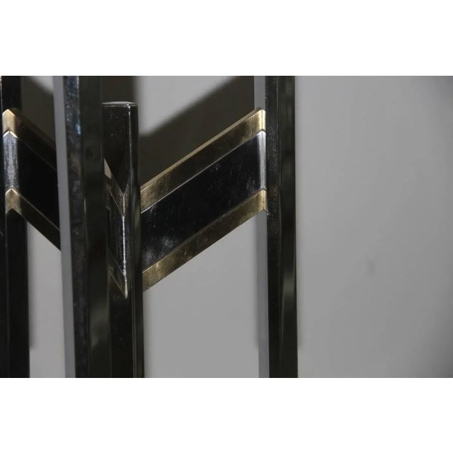 This miniamlist chandelier in metal and brass was designed by Gaetano Sciolari. Up to 250V (Europe/UK Standard).The wiring...