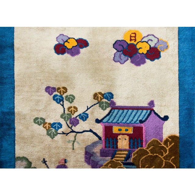 A wonderful early 20th century Chinese pictorial Art Deco rug featuring a scholar's pavilion perched on an outcropping in...