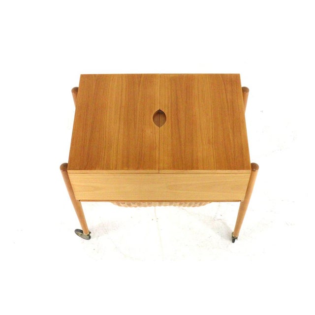 A lovely piece of furniture on slender legs with wheels, originally a haberdashery unit. The top, which slides open,...