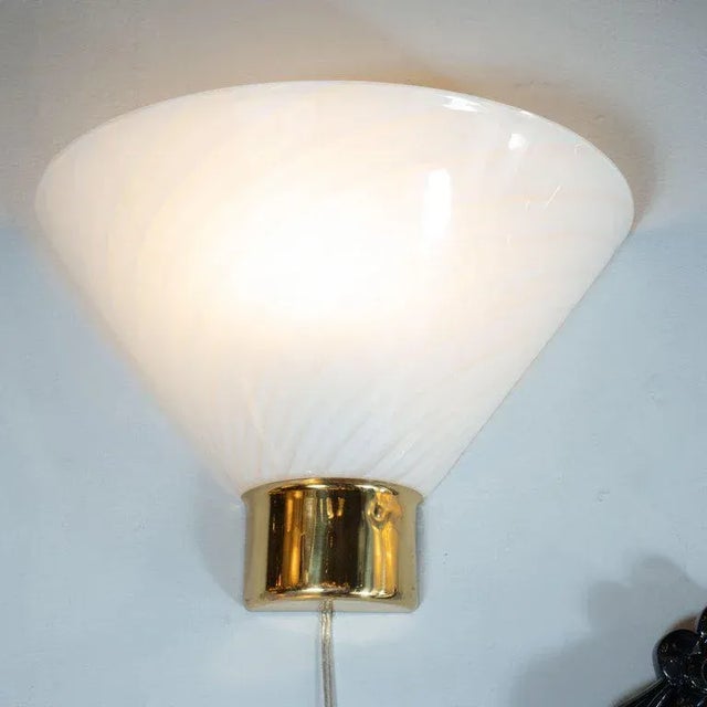 This stunning pair of Mid-Century Modernist glass sconces were realized by the fabled 20th century design studio Fabbian...