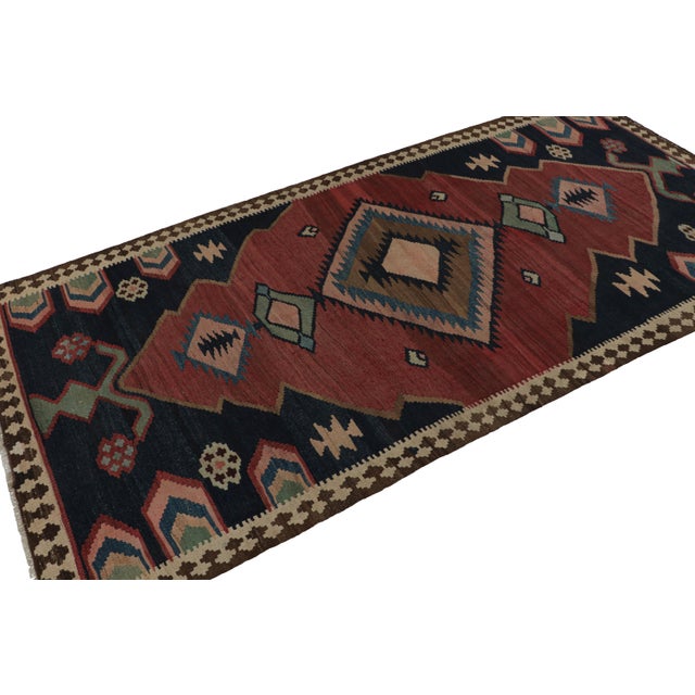 Handwoven in wool, circa 1950-1960, this 5x10 Afghani tribal Kilim rug, with medallion and open field style together, is a...