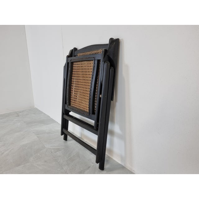 Mid century lacquered wooden and rattan foldable armchair. Made in italy in the 1960s Elegant design. Produced by...