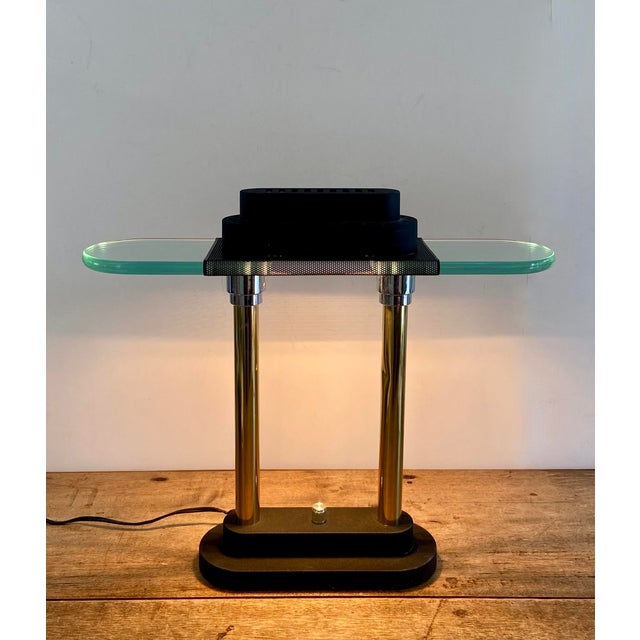Vintage Postmodern halogen table with brass plated double shafts and chrome plated capitals. The top and base are painted...