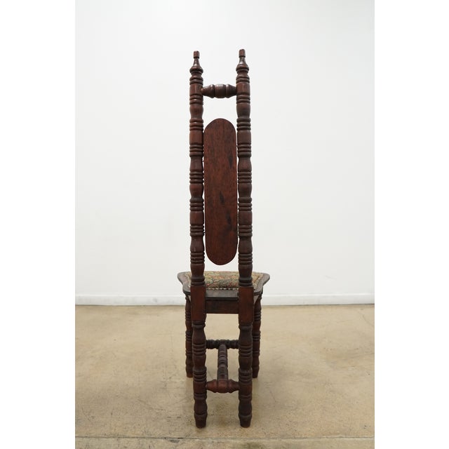 This vintage accent chair features beautifully turned wood detailing and a tall, architectural silhouette accented by...