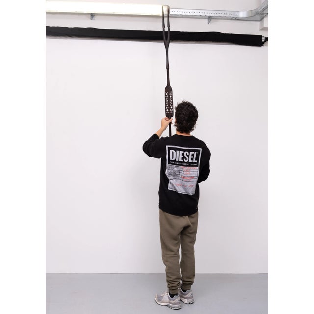 A spear made of hardwood or palm wood. This spear was used as a weapon of war. The openwork carving of this spear depicts...