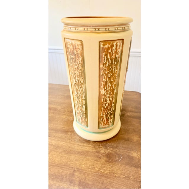 The Roseville Florentine Umbrella Stand is marked 298-18 on the bottom along with Roseville USA. It features a textured,...