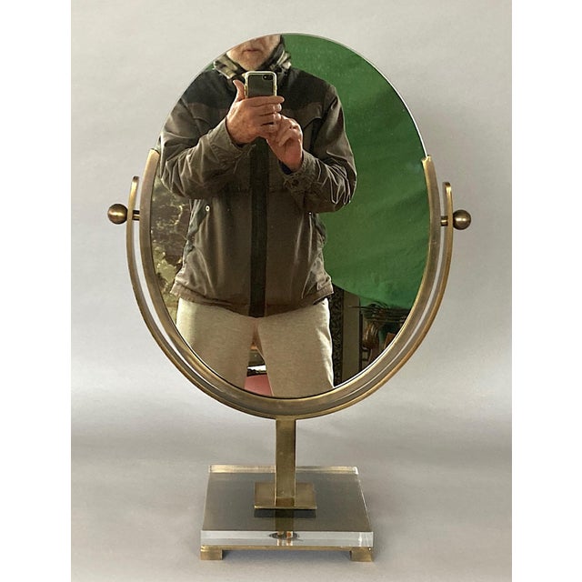 Offering a double-sided vanity/dresser mirror by the famed L.A. designer nicknamed "Mr. Lucite," Charles Hollis Jones, who...