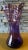 Hand blown from lustrous amethyst glass, this Art Glass Vase bears the imprint of skilled hands. Applied Iridescent amber-...