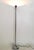 Made in Italy, 1970s. This floor lamp features a steel stem with a spring design. It is a vintage piece, therefore it...