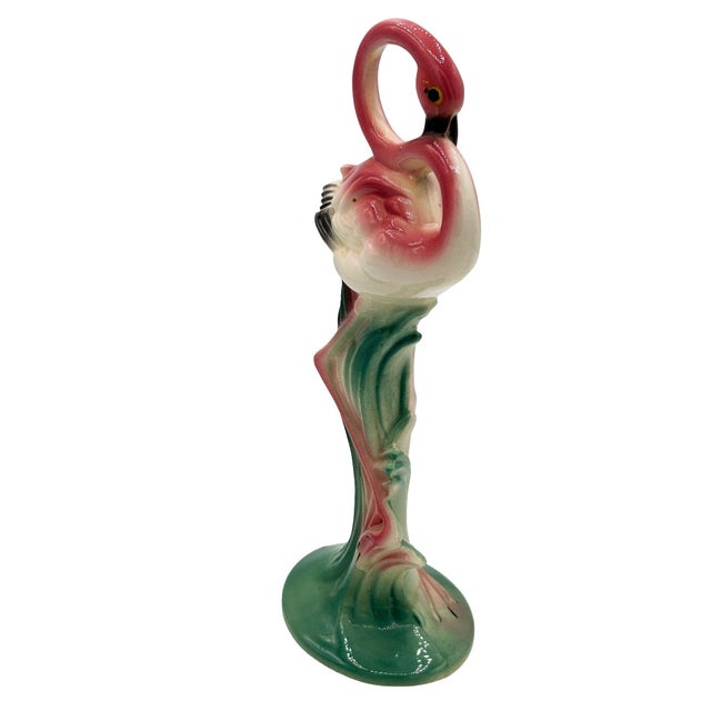 Mid-century pink and green Drinking flamingo ceramic figurine with a bashful expression. The statue detailed a pink...