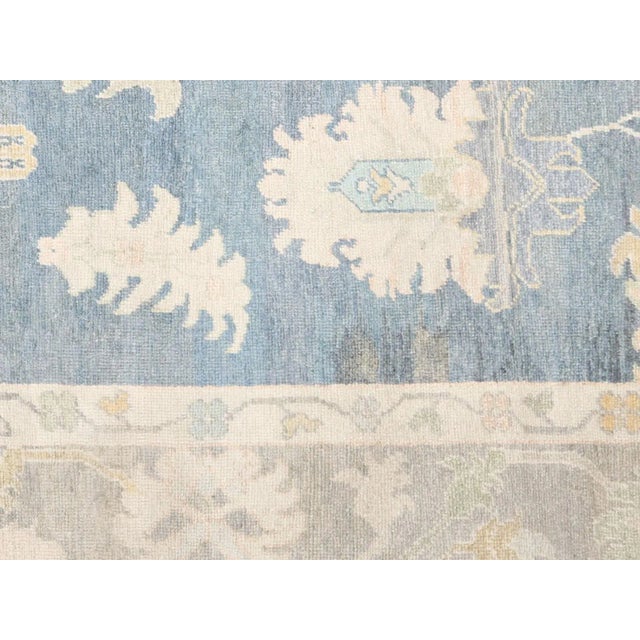 This Vintage Turkish Oushak Rug is a handwoven masterpiece from Western Turkey, measuring 9'2" x 11'5". Oushak has been...