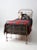 Antique late 19th century iron twin bed frame with clean, linear styling and classic knobbed accents forming a “stick and...