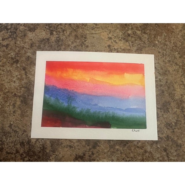 Brilliant coral, crimson, golden yellow, and rose pink flow across this vibrant original watercolor by Michigan artist...